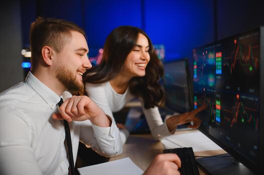 Trader analyzing stock charts on monitors